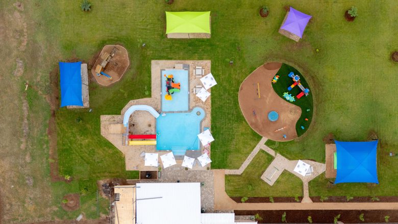 Kids play park and shallow swimming area on the guesthouse lawn